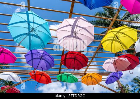 Street decorated with colored umbrellas, island Koh Phangan, Thailand. Hanging colorful umbrellas, on the outdoors Stock Photo