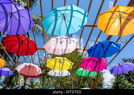 Street decorated with colored umbrellas, island Koh Phangan, Thailand. Hanging colorful umbrellas, on the outdoors Stock Photo