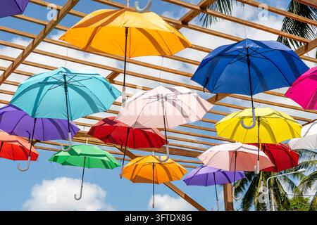Street decorated with colored umbrellas, island Koh Phangan, Thailand. Hanging colorful umbrellas, on the outdoors Stock Photo