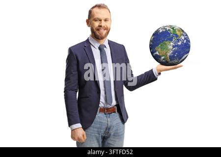 Smiling man holding a small planet earth globe on his palm isolated on white background Stock Photo