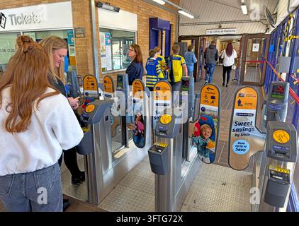 Passengers passing ticket barriers at Warrington Central railway station Stock Photo