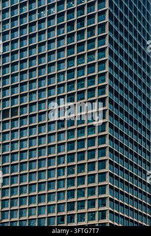 Abstract architecture background, geometric pattern. Close up of building facade in Shenzhen, China with repeating grid of windows and structural Stock Photo