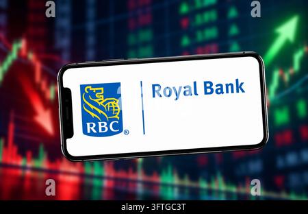 October 15, 2026: In this photo illustraion, A smartphone displaying the Royal Bank logo, against a blurred background of red and green stock market charts, in India on 15 October 2026. (Credit Image: © David Talukdar/ZUMA Press Wire) EDITORIAL USAGE ONLY! Not for Commercial USAGE! Stock Photo
