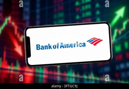 October 15, 2026: In this photo illustraion, A smartphone displaying the Bank of America logo, against a blurred background of red and green stock market charts, in India on 15 October 2026. (Credit Image: © David Talukdar/ZUMA Press Wire) EDITORIAL USAGE ONLY! Not for Commercial USAGE! Stock Photo