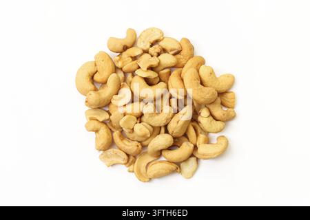Pile of roasted cashew nuts isolated on white background. Golden crunchy cashews in a loose heap, natural snack food with protein and healthy fats. Stock Photo