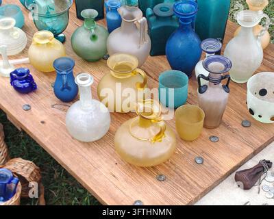 Colorful handmade glass vessels at an outdoor craft market Stock Photo