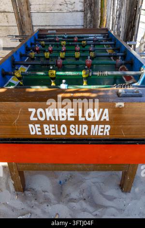 Close up of a weathered foosball table painted with local team colors standing on a beach, Menabe, Belo sur Mer, Madagascar Stock Photo