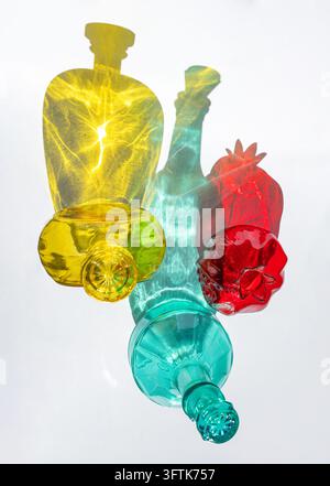 Colorful Glass Bottles with Abstract Light Patterns and Shadows Stock Photo