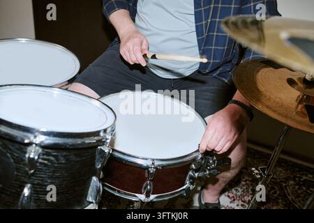 Cropped View of Man Playing Drums during Music Rehearsal Stock Photo