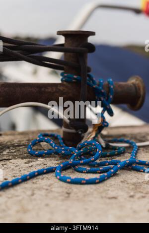 Maline Rope Close-up of blue mooring rope coiled and laid on white fiberglass boat ...