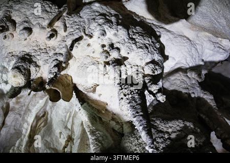 Textured mineral formations inside a natural cave Stock Photo