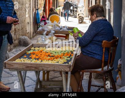 Woman making fresh orecchiette by hand outside her home on Via dell'Arco Basso, Bari Vecchia (Bari's Old Town), Puglia, Italy Stock Photo