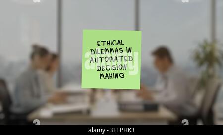 Adhesive note with the lettering "ethical dilemmas in automated decision making" in the prominent position, superimposed on a blurred background showi Stock Photo