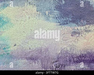 Rough textured background featuring brushstrokes of purple, blue, and green paint, creating an abstract and artistic design Stock Photo