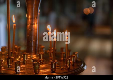 Orthodox Church. Christianity. Festive interior decoration with burning candles and icon in traditional Orthodox Church on Easter Eve or Christmas. Religion faith pray symbol Stock Photo