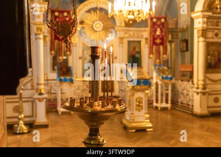 Orthodox Church. Christianity. Festive interior decoration with burning candles and icon in traditional Orthodox Church on Easter Eve or Christmas. Religion faith pray symbol Stock Photo