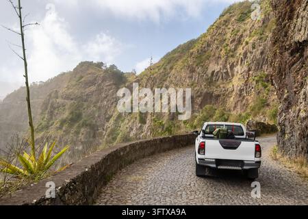 Pickup truck driving along mountain cobblestone road on Santo Antao Stock Photo