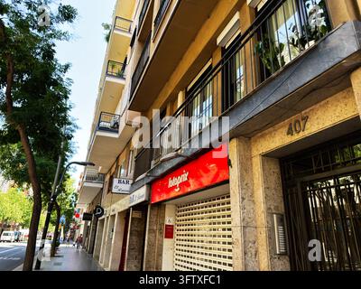 Barcelona , Spain - June 27, 2026: Street pedestrians cross beneath ...
