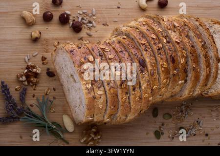 Multigrain Wholemeal Bread Sliced on Wooden Board Stock Photo