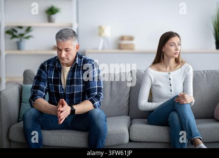 Depressed mature man and woman having relationship problems, going through marital crisis at home Stock Photo