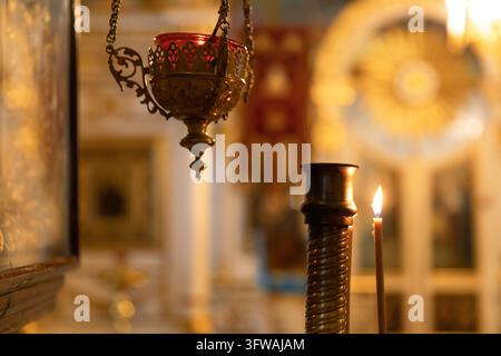 Orthodox Church. Christianity. Festive interior decoration with burning candles and icon in traditional Orthodox Church on Easter Eve or Christmas. Religion faith pray symbol Stock Photo