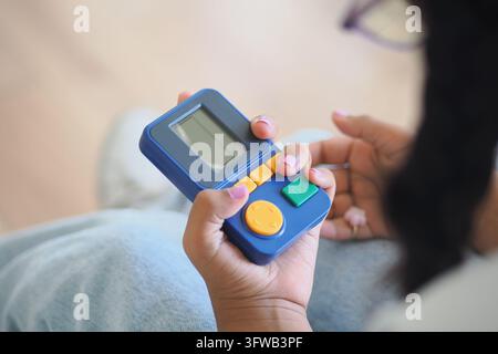 a child holding a handheld retro arcade and game console  Stock Photo