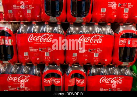 RIGA, LATVIA. 12th March 2026. Large shelf display with rows of red Coca-Cola two-pack plastic bottles in a grocery store aisle in Riga, Latvia. Stock Photo