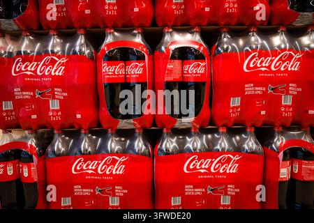 RIGA, LATVIA. 12th March 2026. Large shelf display with rows of red Coca-Cola two-pack plastic bottles in a grocery store aisle in Riga, Latvia. Stock Photo