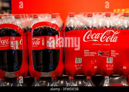 RIGA, LATVIA. 12th March 2026. Close up of stacked multi-packs of Coca-Cola plastic bottles on a supermarket display shelf in Riga, Latvia. Stock Photo