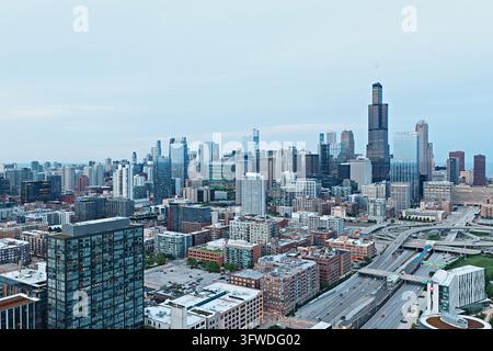 Aerial view of the skyline with Willis Tower above the West Loop, a glass high rise and the expressway interchange on an overcast evening, Chicago Stock Photo