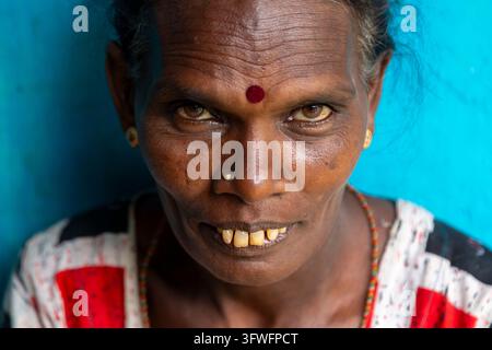 Close portrait of a woman with a red bindi against a blue wall, Uva Province, Ella, Sri Lanka Stock Photo
