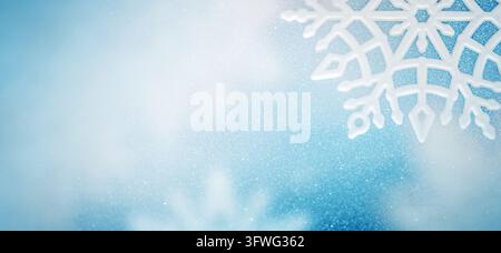 White Decorative Snowflake on a Pale Blue Glitter Background with Copy Space Stock Photo