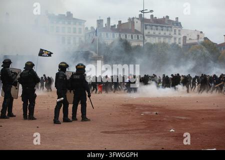 Police officers gather amid smoke during a protest in Marseille, France ...