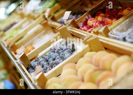 Fresh Organic Fruits Displayed in Wooden Crates at Supermarket Stock Photo