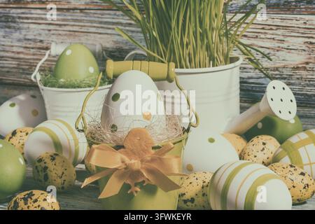Easter still life, postcard - Rustic still life with Easter eggs in buckets, watering can and wooden background Stock Photo