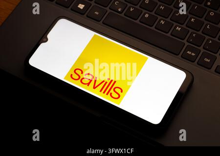 In this photo illustration, the Savills logo is seen displayed on a ...