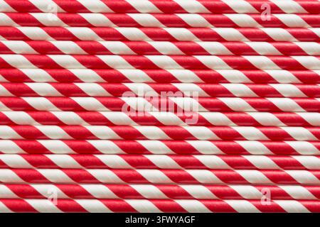 Christmas red straws as background. Top view. Pattern. Stock Photo