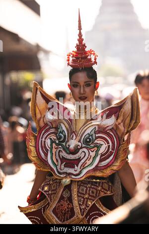 Bangkok, Thailand - February 1, 2026: A performer wearing an ornate traditional Thai costume with a large decorative mask and headdress stands... Stock Photo