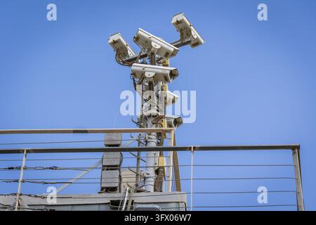 Alicante, Spain August 20. 2026 multiple surveillance cameras mounted on a security pole monitoring airport facilities and public areas outdoors. Stock Photo