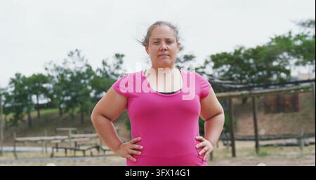 Portrait of caucasian woman wearing pink t-shirt holding hands on hips Stock Photo