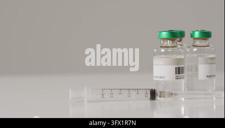 Image of close up of vaccine vials on white background Stock Photo