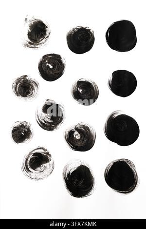 Hand drawn black ink painted circles pattern on white background. Minimalist modern artistic texture with round paint brush strokes, swirl graphic ele Stock Photo