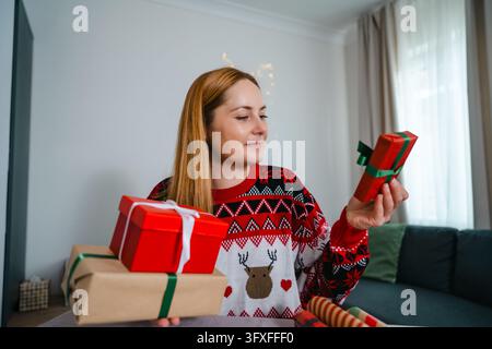 Christmas preparation with wrapping paper, scissors and gift boxes Stock Photo