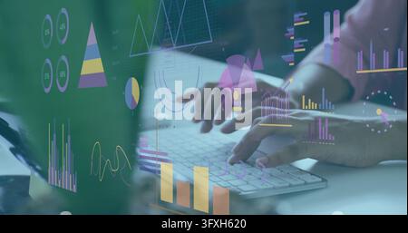 Typing hands analyzing data at desk with wireless keyboard, holographic charts, long-sleeve cuff. Analytics, visualization, dashboard, monitor, office Stock Photo