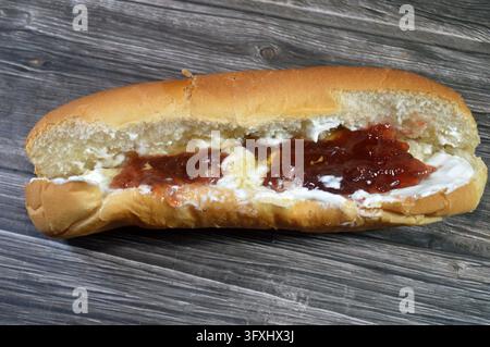 a strawberry jam, Honey and Eshta (Clotted Cream) Sandwich or Labnah, jam and Honey Sandwich, served in a soft bun with layers of rich cream ( eshta, Stock Photo