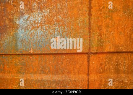 heavily rusted, oxidized and weathered steel plate with orange corrosion patterns Stock Photo