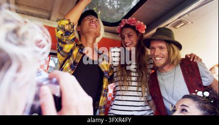 Diverse friends enjoy a lively moment on a bus, with copy space. Captured in a casual setting, the group's joy is infectious and heartwarming. Stock Photo