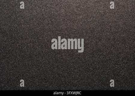 Black packaging foam texture full frame abstract background. Dark grey rough polyurethane foam surface, top view. Background of micro porous spongy ma Stock Photo