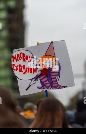 A sign with critics about Emmanuel Macron during the demonstration by ...