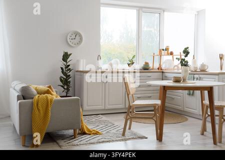 Home interior design, open plan living room and kitchen with modern furniture, cozy apartment lifestyle and minimalist decor in a bright sunny space Stock Photo